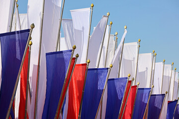 Russian flags waving on background of blue sky. Symbol of Russia