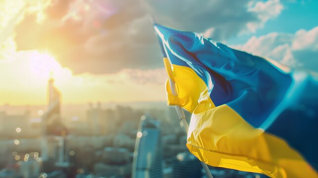 Fototapeta Ukraine Flag Waving Proudly Blue Sky with Clouds blured city view. Independence Day concept.