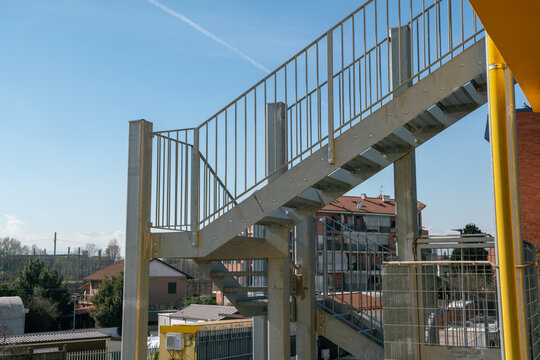 fire escape staircase, pedestrian passage for emergency exit. particular structure in galvanized stainless steel, with detail of the steel beams and their bolting.
