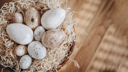 Easter eggs in a nest on a wooden background. Vintage style.