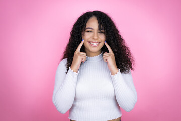 African american woman wearing casual sweater over pink background very happy and excited making...