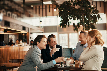 Business people having a meeting at an indoor cafe