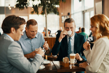Business people having a meeting at an indoor cafe