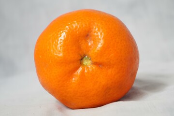 A large orange on a white background