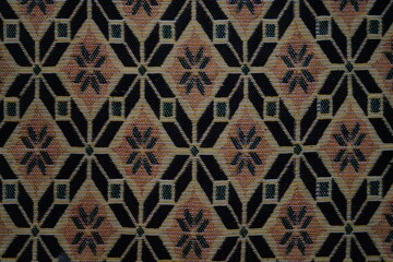 A patterned carpet with a black and brown color scheme