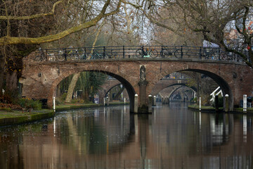 Fototapeta premium Utrecht, the Netherlands. 2 December 2023. Oudegracht and yard (old canal) with Traditional houses in the city centre of Utrecht.