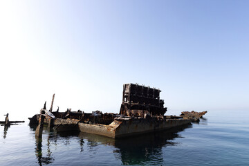 A submerged rusted tugboat shipwreck in the eastern coast of Bahrain sea.