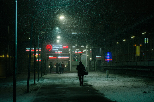 Passengers at station at snowy night