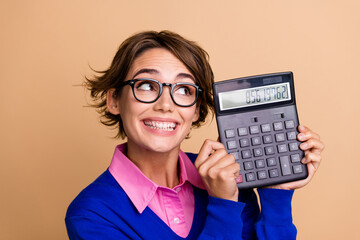 Photo portrait of pretty young girl look excited calculator wear trendy blue outfit isolated on...
