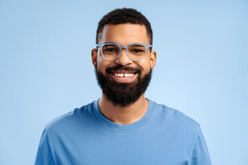 Attractive, smiling, bearded African American man wearing stylish eyeglasses looking at camera