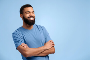 Handsome African American man wearing casual clothes with crossed arms looking away, copy space