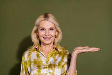 Photo of gorgeous cheerful pretty lady introduces empty space seasonal proposition promo empty...
