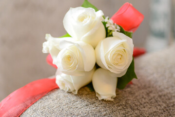 bridal bouquet of white roses and pink ribbon