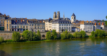 Bell towers of the Orléans Cathedral of Sainte Croix ("Holy Cross") peeking above apartment buildings on the Loire riverside, in the French department of Loiret in the Center of France