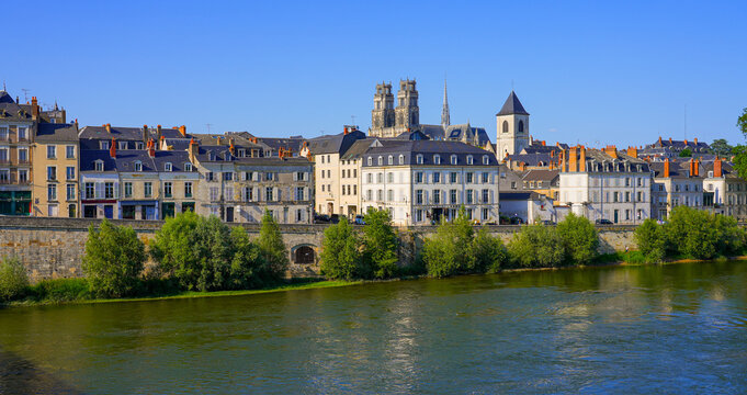 Bell towers of the Orl&eacute;ans Cathedral of Sainte Croix ("Holy Cross") peeking above apartment buildings on the Loire riverside, in the French department of Loiret in the Center of France