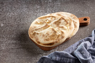 Pita bread on the table. Arabic lebnani bread.