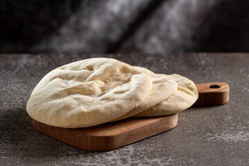 Pita bread on the table. Arabic lebnani bread.