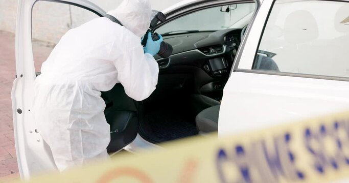 Forensic, investigation and photographer for evidence in crime scene car for accident, burglary and research analysis. Science, csi and photography with rear view in transport vehicle for observation