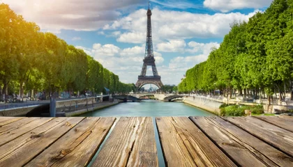 Behangcirkel background with wooden deck table and eiffel tower in paris © Charlotte