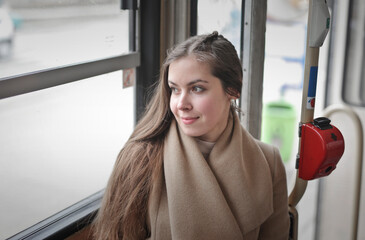 portrait of a young woman in a  tram - 763545573