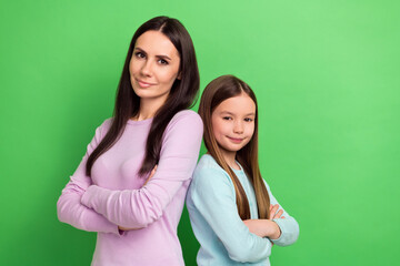 Photo of two people mother daughter folded arms posing empty space isolated on bright green color background