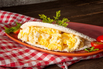 Tapioca Pancake with eggs Brazilian manioc food in top front view red plate