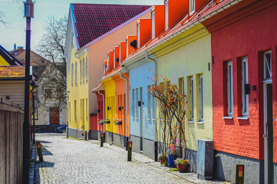 Scandinavian street, Row of pastel painted colorful houses. Residential area in Sweden. Swedish wooden colorful houses.