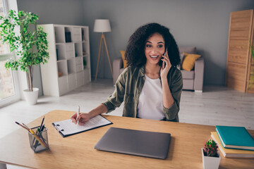 Photo of smiling positive lady partner dressed shirt communicating modern gadget writing list...