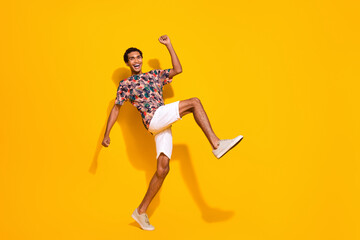 Fototapeta na wymiar Full length body photo of funky guy big steps to his dream resort place for vacation in tropics isolated on yellow color background