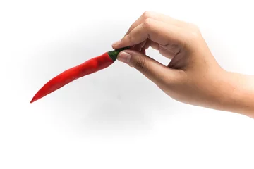 Keuken spatwand met foto Hand picking up red hot chili pepper isolated on white background clipping path © dwiangga