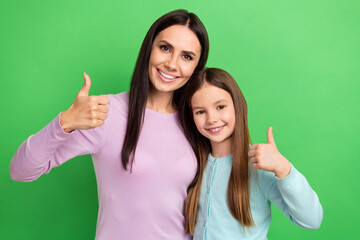 Photo of confident positive mommy small girl wear casual outfits showing thumbs up isolated green...