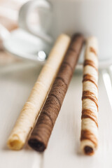 Assorted Chocolate and Vanilla Cream Filled Wafer rolls on white table.