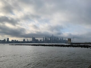 Fototapeta na wymiar New York downtown with low clouds over Hudson bay
