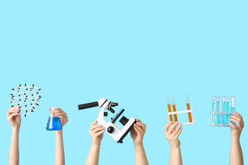 Female hands holding filled flask with test tubes, microscope and molecular model on blue...