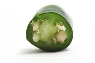 Close-up sliced green hot chili pepper isolated on white background clipping path