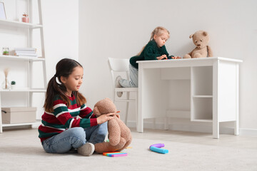 Little girls playing at home. Autistic disorder concept