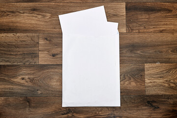 Wedding invitation card mockup and white envelope on wood table. Blank card mockup