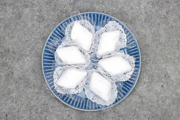 plate with algerian traditional cookies named makrout is a almond paste forming diamond shape and covered with icing sugar