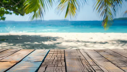 Fotobehang Wood table top on blurred blue sea and white sand beach background © Oleksiy