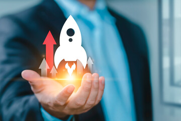 Rocket being fast head up. Startup business concept, Businessman holding rocket icon and up arrow...