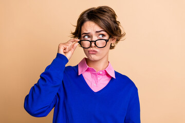 Photo portrait of pretty young girl touch specs look unsure empty space wear trendy blue outfit...