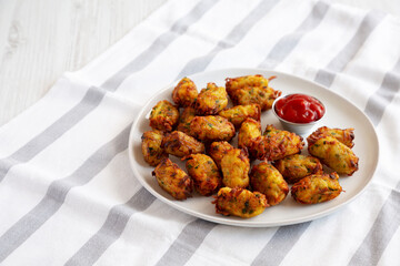 Homemade Fried Tater Tots on a Plate, side view. Copy space.