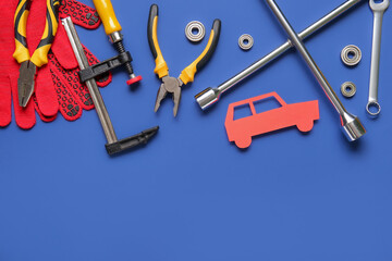 Set of mechanic instruments and paper car on blue background. Mechanic concept