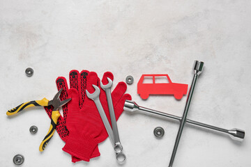 Set of mechanic instruments and toy car on white grunge background. Mechanic concept