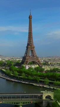 Vertical video. Aerial view of Tour Eiffel Tower and Seine River bridge and historical city center