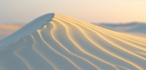 the subtle interplay of light and shadow on a gently undulating sand dune at dusk, emphasizing the quiet beauty of the desert