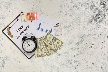 Clipboard with text TIME IS MONEY, alarm clock and dollar banknotes on white grunge background. Top view