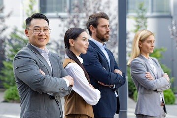 Three business professionals stand confidently outdoors, embodying teamwork and success in a corporate setting.