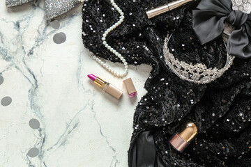 Female prom dress with tiara, lipstick and necklace on white grunge background