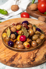 Mixed olives. Special mixed olives prepared with various olives on a wooden serving board. Close up